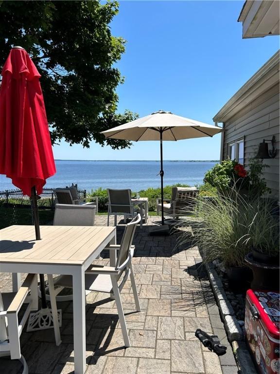 view of patio with a water view