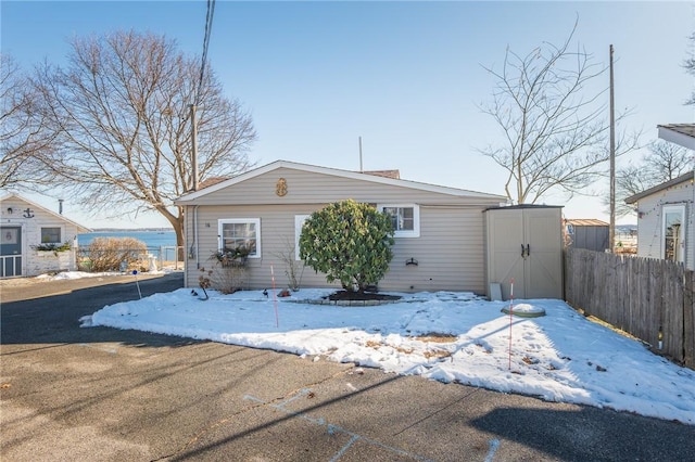 view of front of home with a storage shed