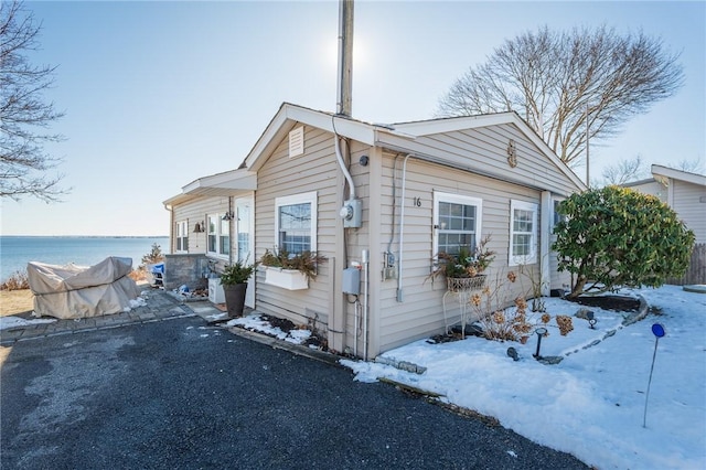 view of snowy exterior featuring a water view