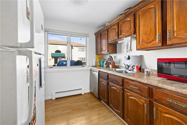 kitchen with dishwasher, a baseboard radiator, sink, white refrigerator, and light hardwood / wood-style floors