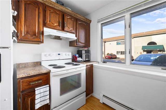 kitchen featuring a baseboard heating unit and white appliances