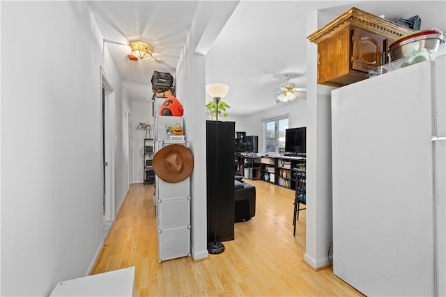 hallway with light hardwood / wood-style floors