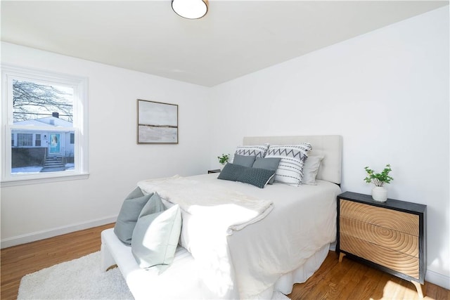 bedroom with wood-type flooring