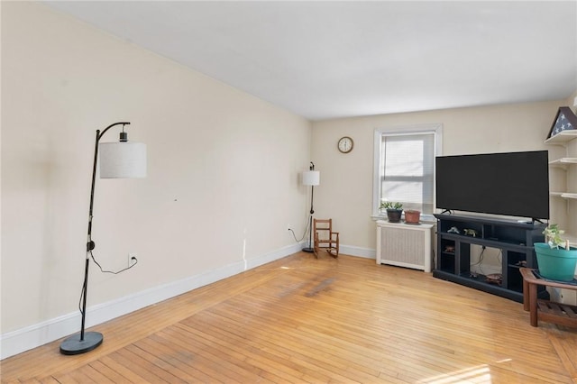 living room with radiator and light wood-type flooring