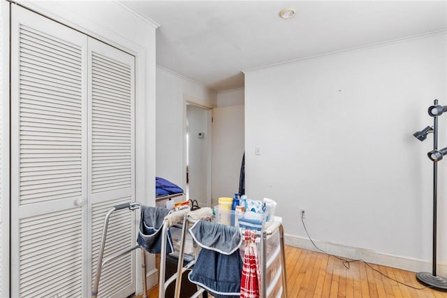 misc room featuring hardwood / wood-style floors and crown molding