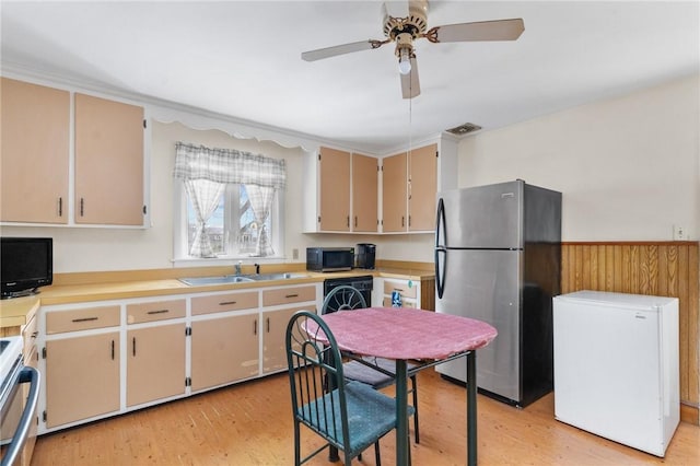 kitchen with range with electric cooktop, refrigerator, sink, stainless steel fridge, and light hardwood / wood-style floors