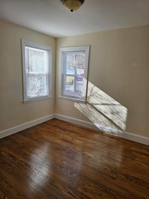 empty room with dark wood-type flooring