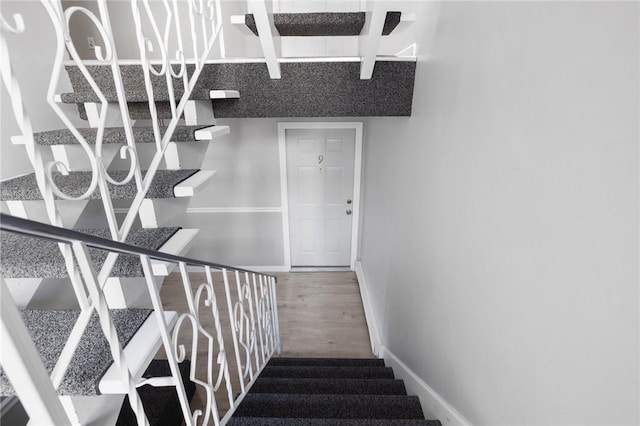 stairs with hardwood / wood-style floors