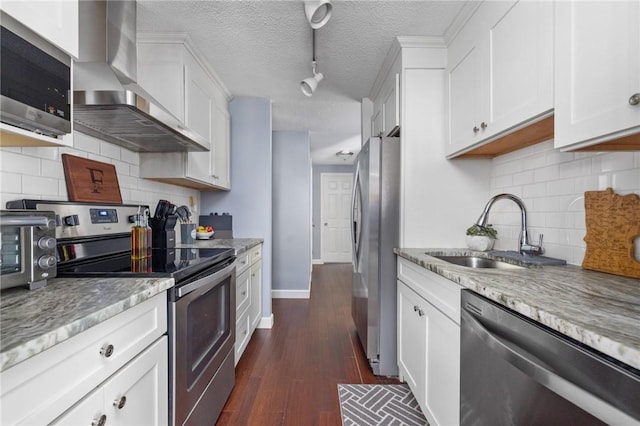 kitchen with wall chimney exhaust hood, sink, white cabinetry, dark hardwood / wood-style floors, and stainless steel appliances