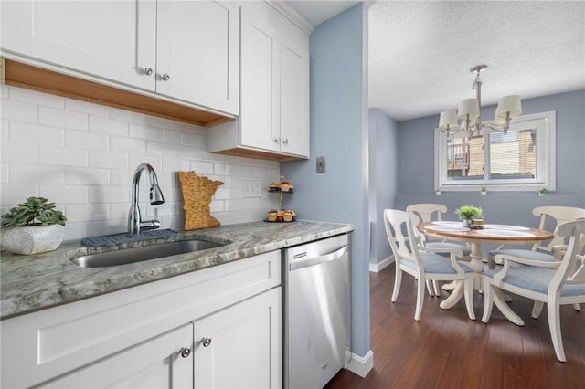 kitchen with white cabinetry, sink, decorative light fixtures, and dishwasher