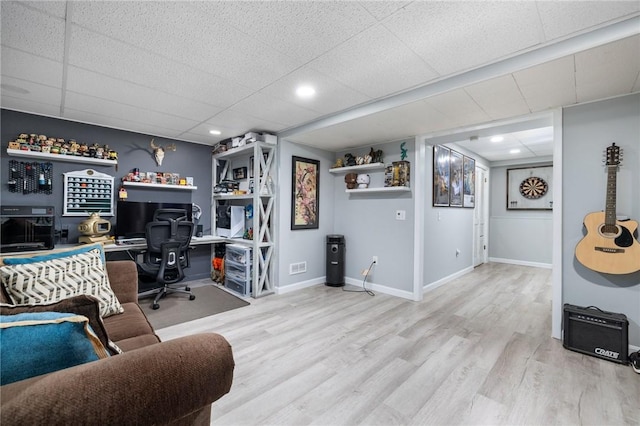 office area with a drop ceiling and light hardwood / wood-style floors