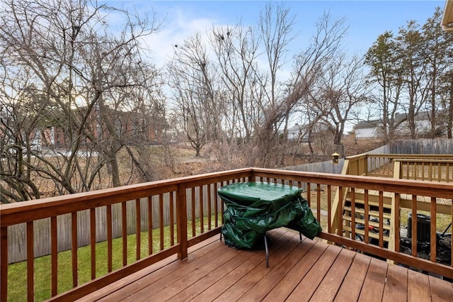 wooden terrace featuring a yard