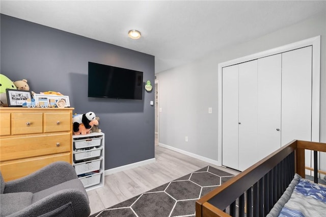 bedroom with a closet and light hardwood / wood-style flooring