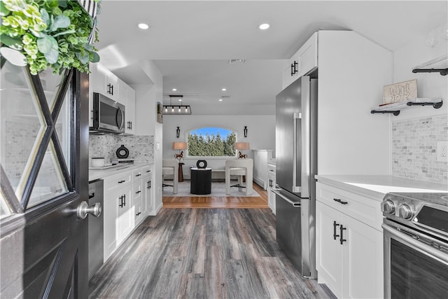 kitchen featuring decorative backsplash, stainless steel appliances, dark hardwood / wood-style floors, and white cabinets