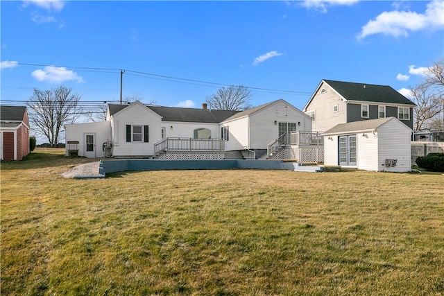 back of house featuring an outdoor structure and a lawn