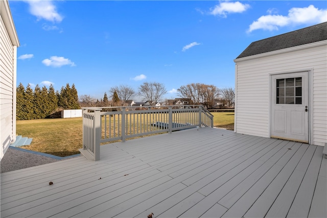 wooden terrace featuring a lawn