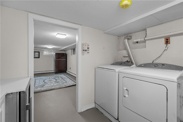 laundry area with independent washer and dryer, a textured ceiling, and baseboard heating