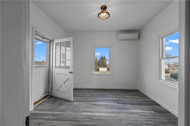 interior space with dark wood-type flooring and a wall mounted AC