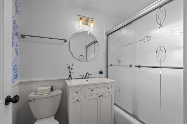 full bathroom with vanity, enclosed tub / shower combo, and toilet