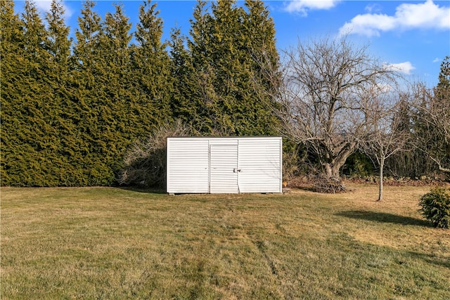 view of outdoor structure featuring a lawn