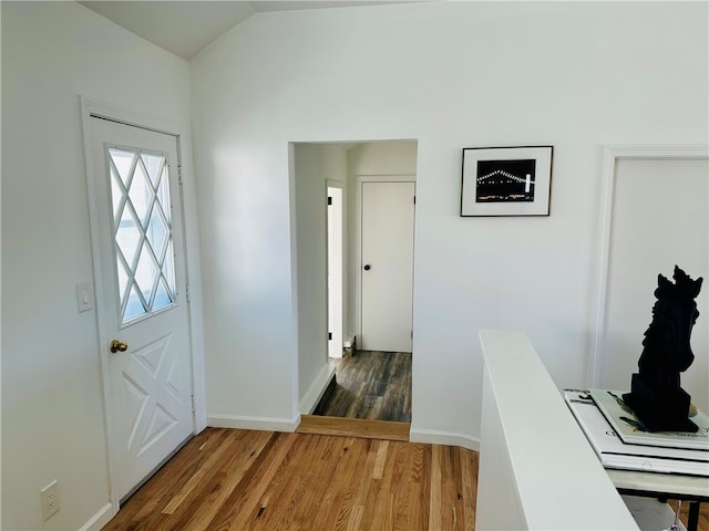 entryway with lofted ceiling and dark hardwood / wood-style floors