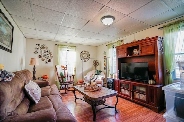 living room featuring hardwood / wood-style flooring and a paneled ceiling