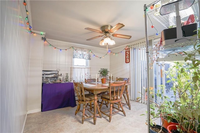 dining area featuring ceiling fan and ornamental molding