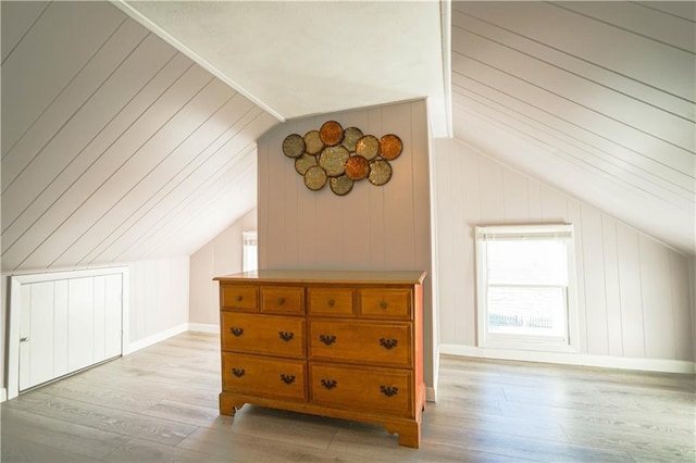 additional living space with lofted ceiling and light hardwood / wood-style floors