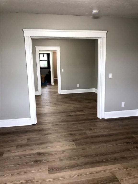 unfurnished room featuring dark hardwood / wood-style floors