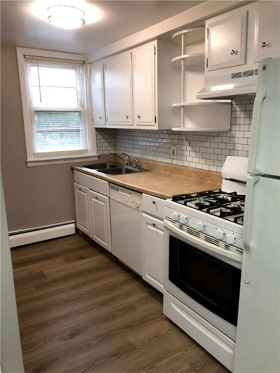 kitchen featuring sink, white appliances, white cabinetry, dark hardwood / wood-style flooring, and a baseboard radiator