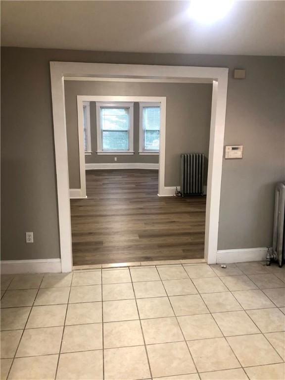 interior space featuring radiator heating unit and light tile patterned floors