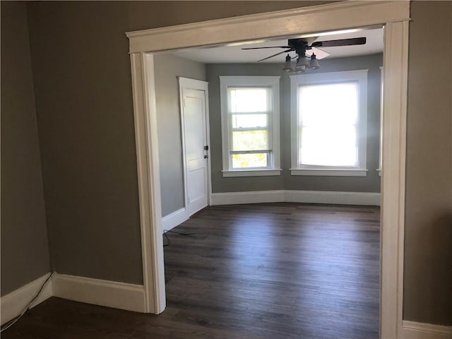 spare room with ceiling fan and dark hardwood / wood-style flooring