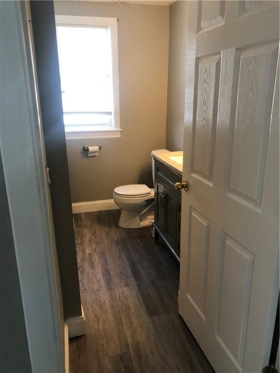 bathroom with vanity, hardwood / wood-style flooring, and toilet