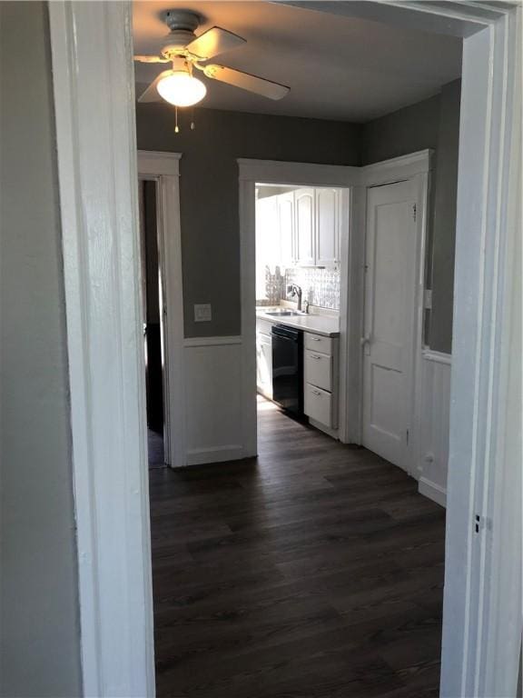 corridor featuring dark wood-type flooring and sink