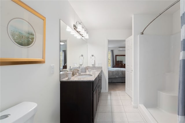 bathroom with walk in shower, tile patterned floors, toilet, and vanity