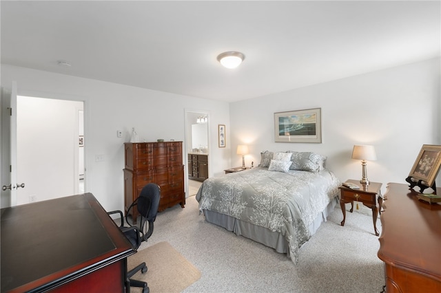 carpeted bedroom featuring connected bathroom