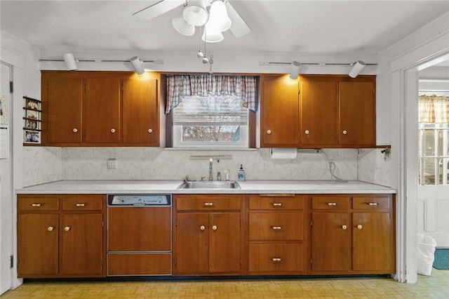 kitchen featuring tasteful backsplash, dishwasher, sink, and ceiling fan