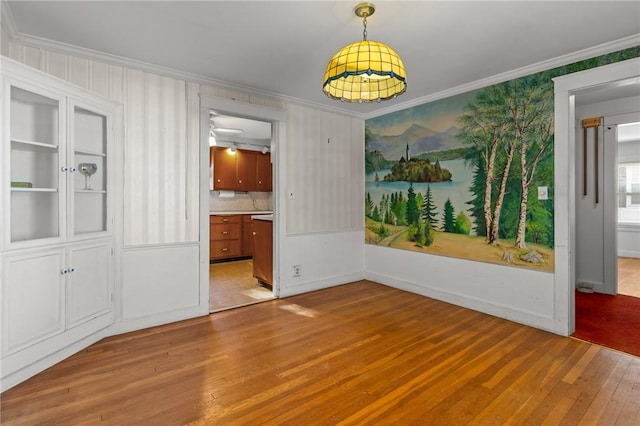 interior space featuring ornamental molding and light hardwood / wood-style floors