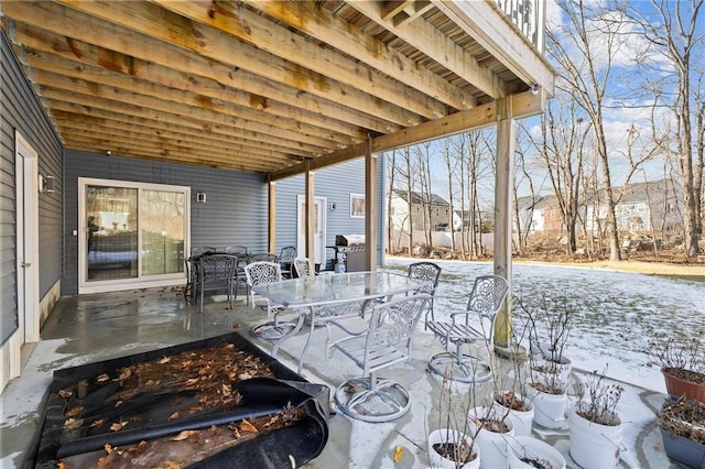 snow covered patio featuring area for grilling