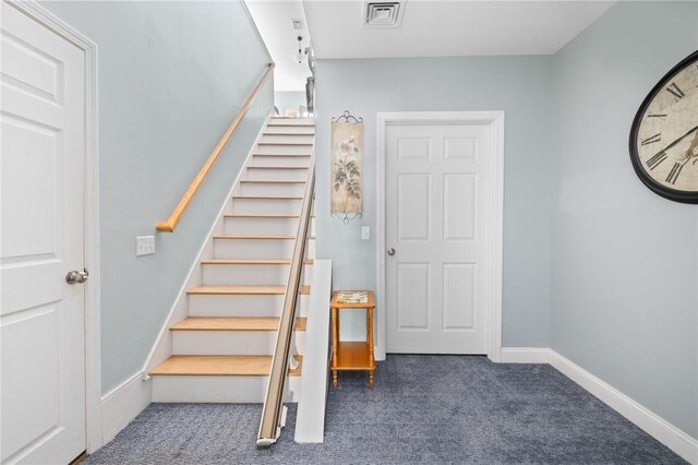 stairs with baseboards, visible vents, and carpet floors