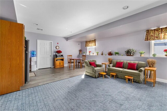 living area with recessed lighting, baseboards, and wood finished floors