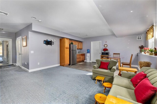 carpeted living room featuring baseboards and visible vents