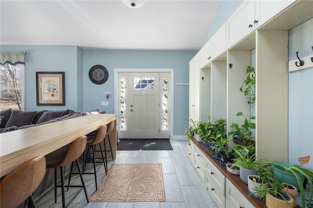 mudroom with plenty of natural light and light tile patterned floors