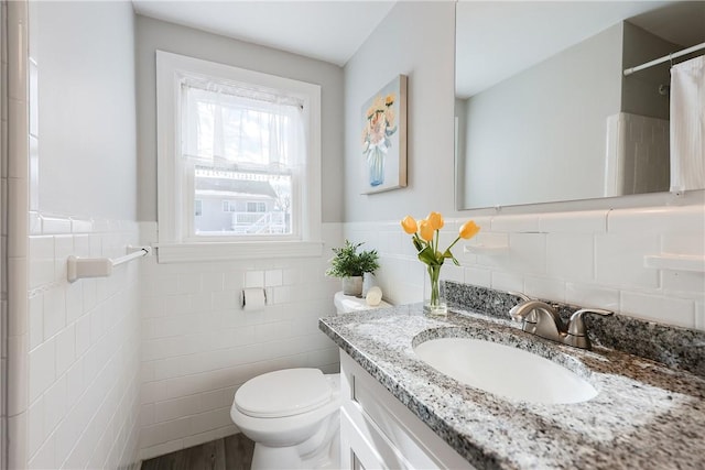 bathroom featuring vanity, tile walls, curtained shower, and toilet