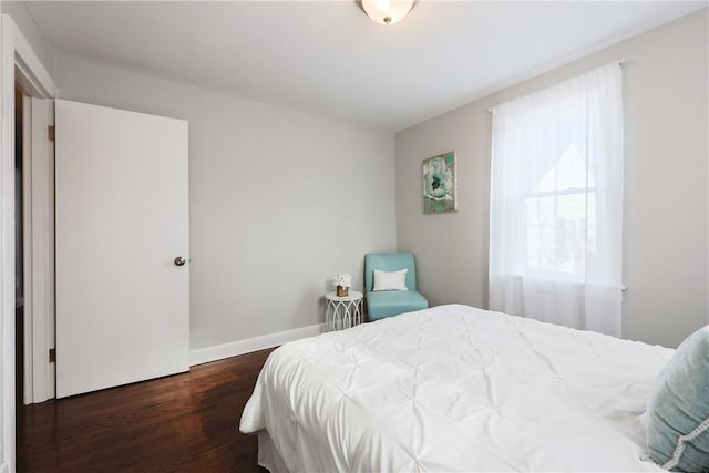 bedroom with dark wood-type flooring