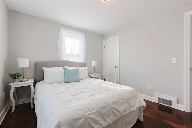 bedroom with dark wood-type flooring