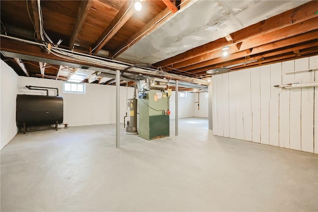 basement featuring heating unit and water heater