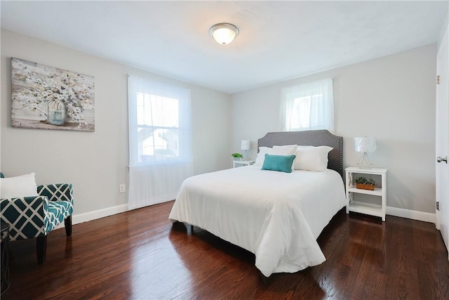 bedroom featuring dark wood-type flooring and multiple windows