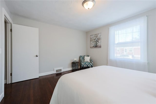 bedroom with dark hardwood / wood-style flooring