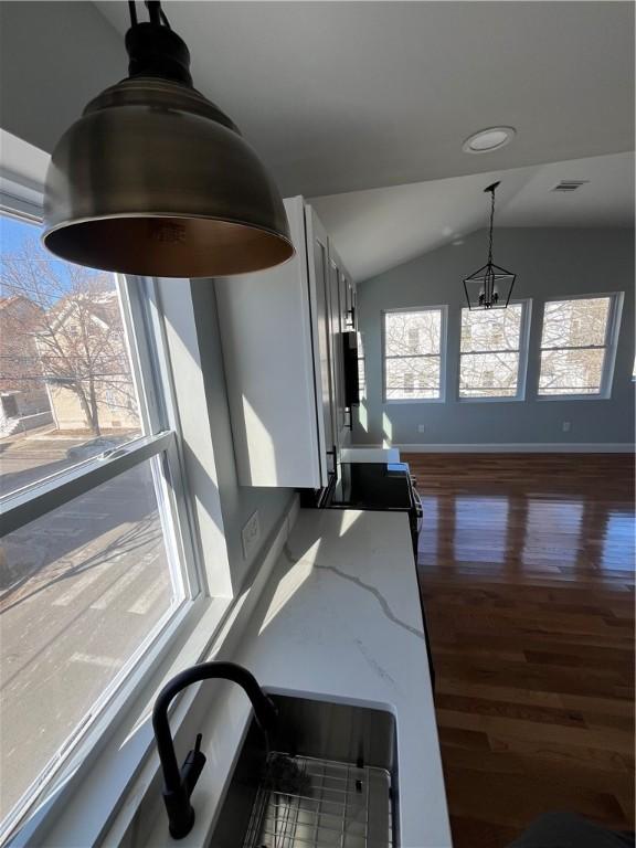 interior details featuring sink, hardwood / wood-style floors, and electric range oven